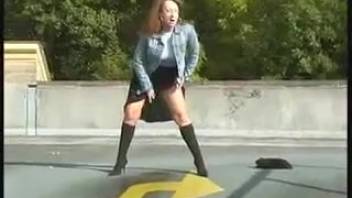 Lady urinating while departing from a subterranean garage