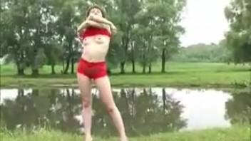 Lady in crimson urinating beside the lake