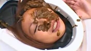 Oriental female defecates on her partner's face
