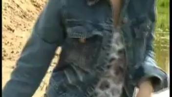 Girl peeing on sandy shore