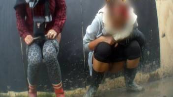 Girls urinating in a public spot