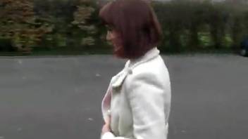 Urinating lady in a white jacket