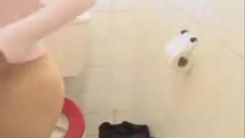 Adorable girl defecating in the bathroom and recording herself on video